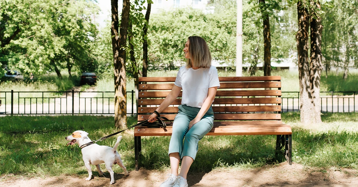 woman with dog on Park Bench in Sarasota